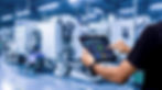 Smart industry control concept.Hands holding tablet on blurred automation machine as backg