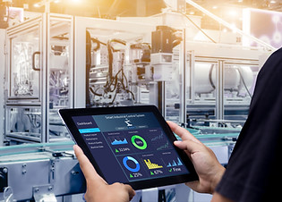 Smart industry control concept.Hands holding tablet on blurred automation machine as backg