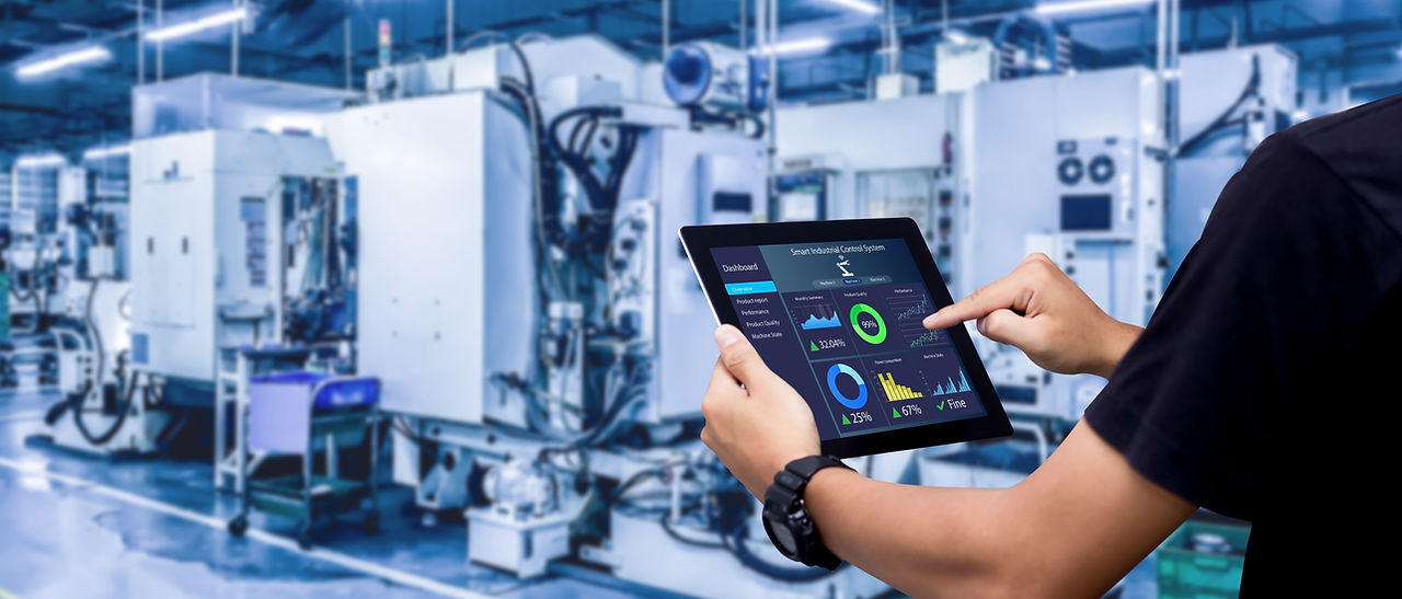 Smart industry control concept.Hands holding tablet on blurred automation machine as backg